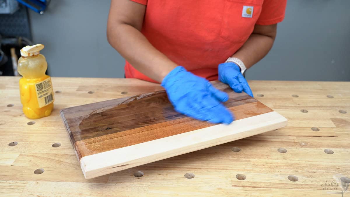 Applying the final finish to the mixed wood DIY cutting board