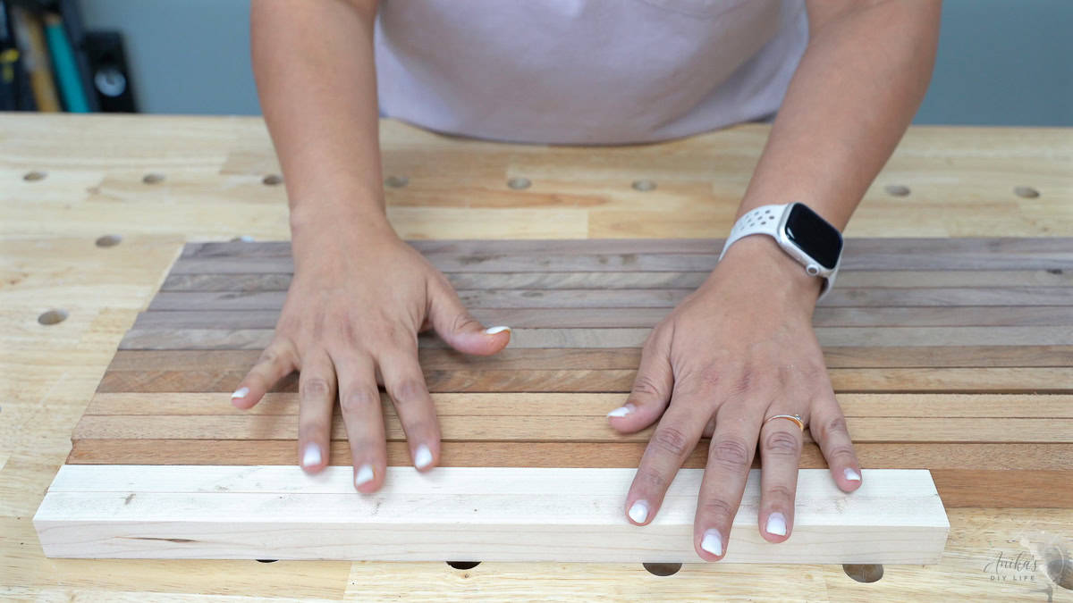 Arranging the wood boards into a pattern for the cutting board