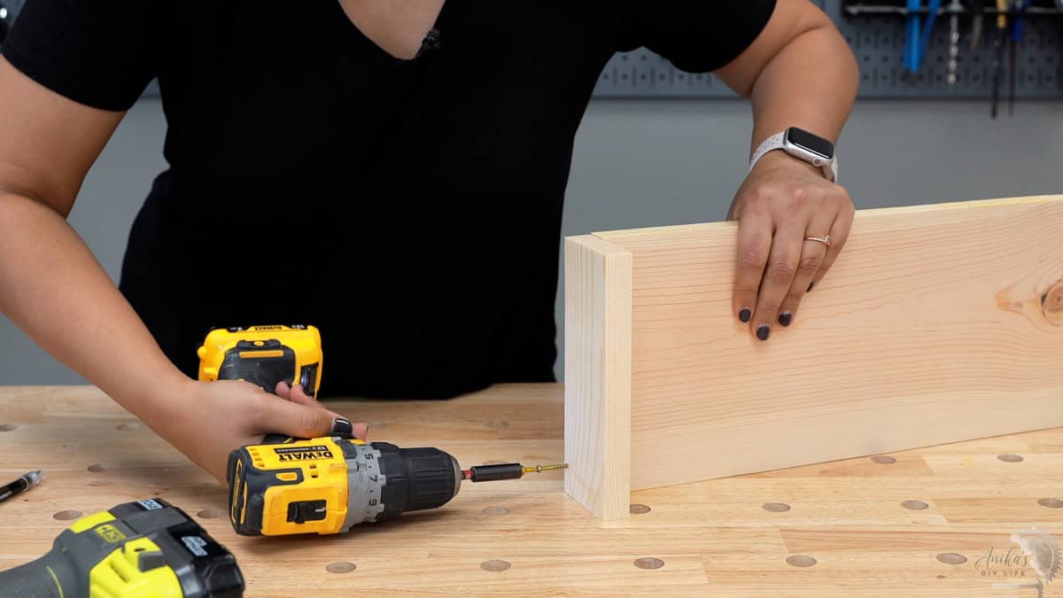 Attaching the second side to the base using a drill and screws