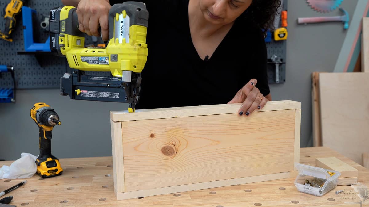Attaching the long sides to the based using a nail gun