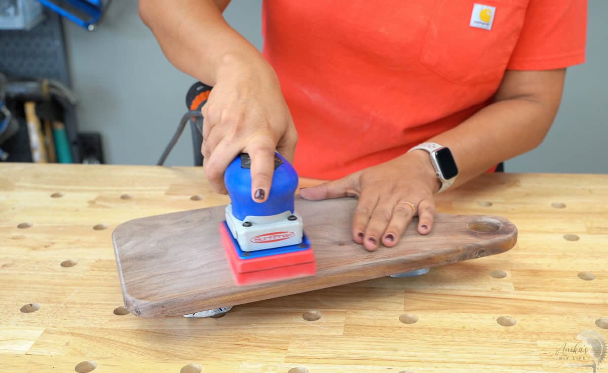 sanding the cutting board with extra fine sand paper