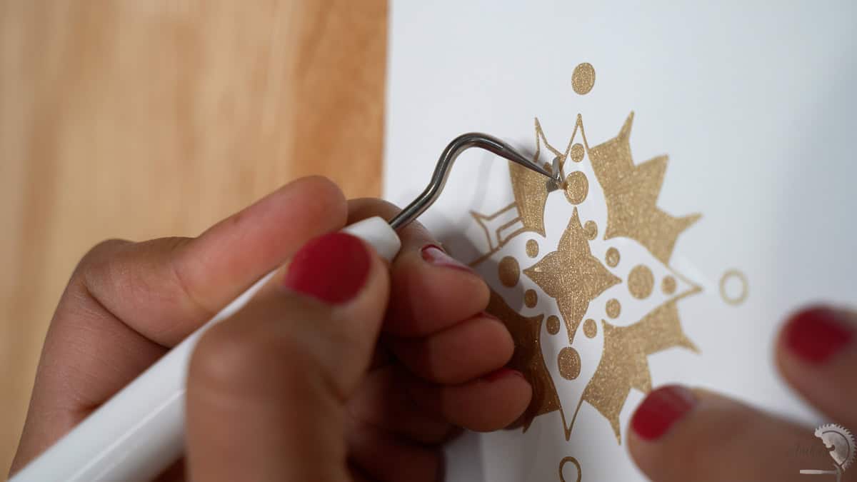 weeding the gold design cut on a cricut machine