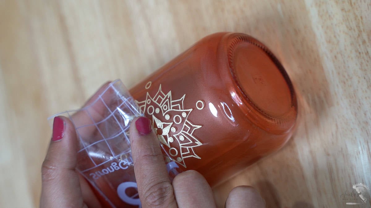 using transfer tape to apply design to the glass bottle