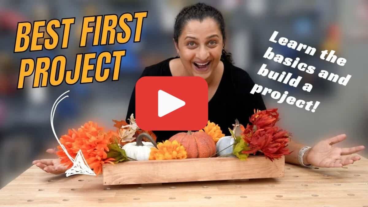 Image of Anika with DIY wood centerpiece and text overlay with Youtube play button