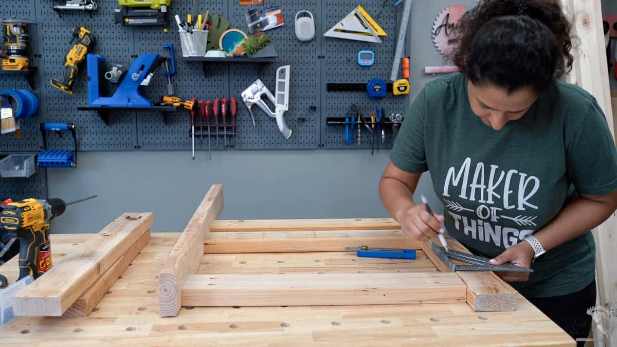 Anika building the sides for the table saw stand with pocket hole screws