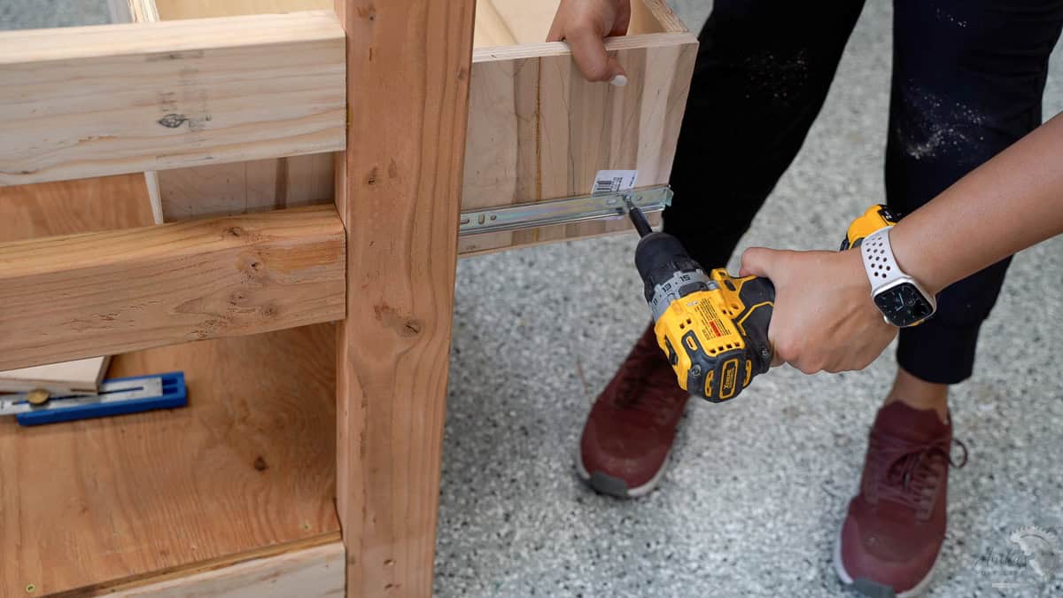 installing the drawer slides into the table stand