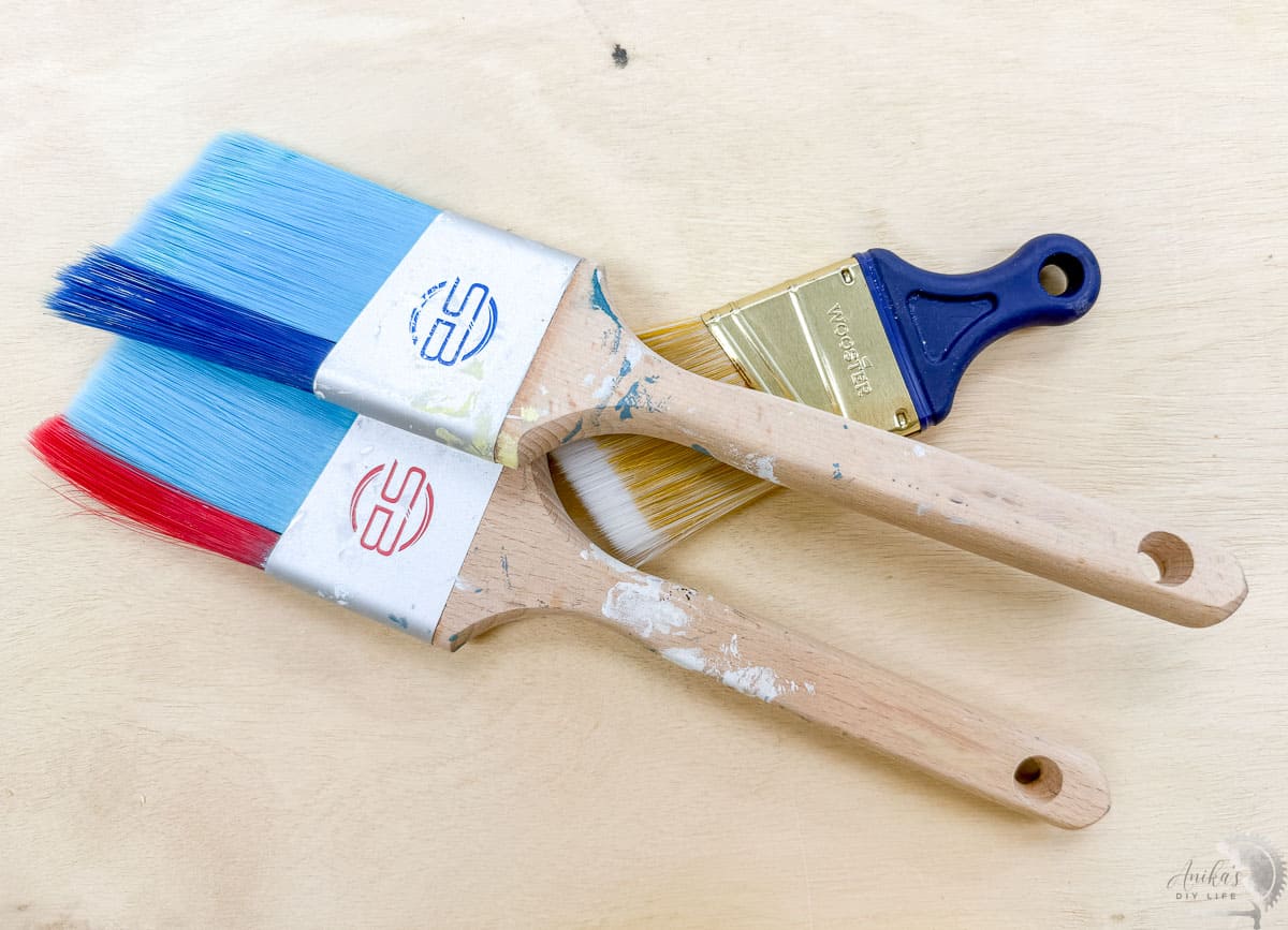 paint brushes on a wood surface
