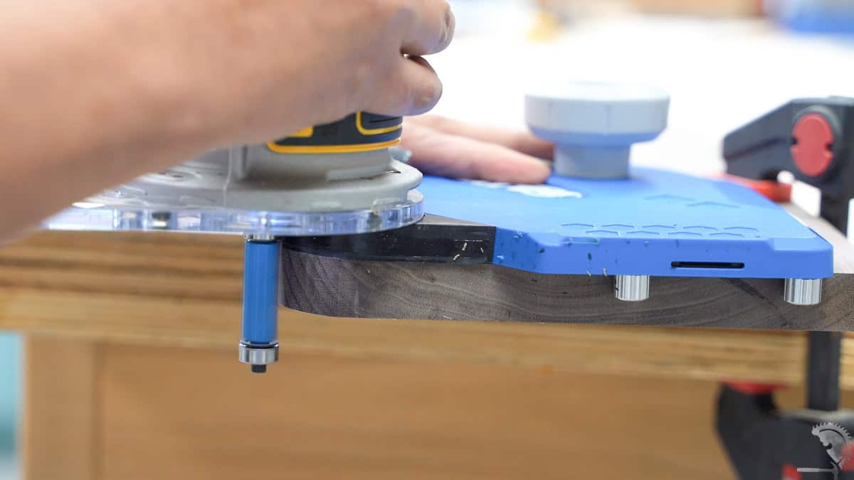 trimming edge of board using a flush trim router bit and template