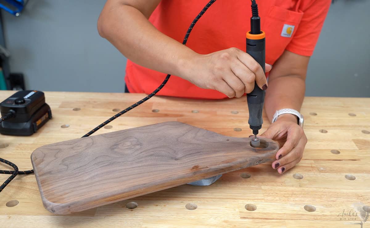 using a rotary tool to sand the inside of the hole