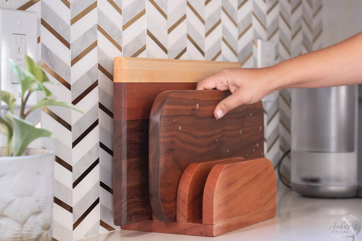 Woman adding a cutting board to the cutting board stand