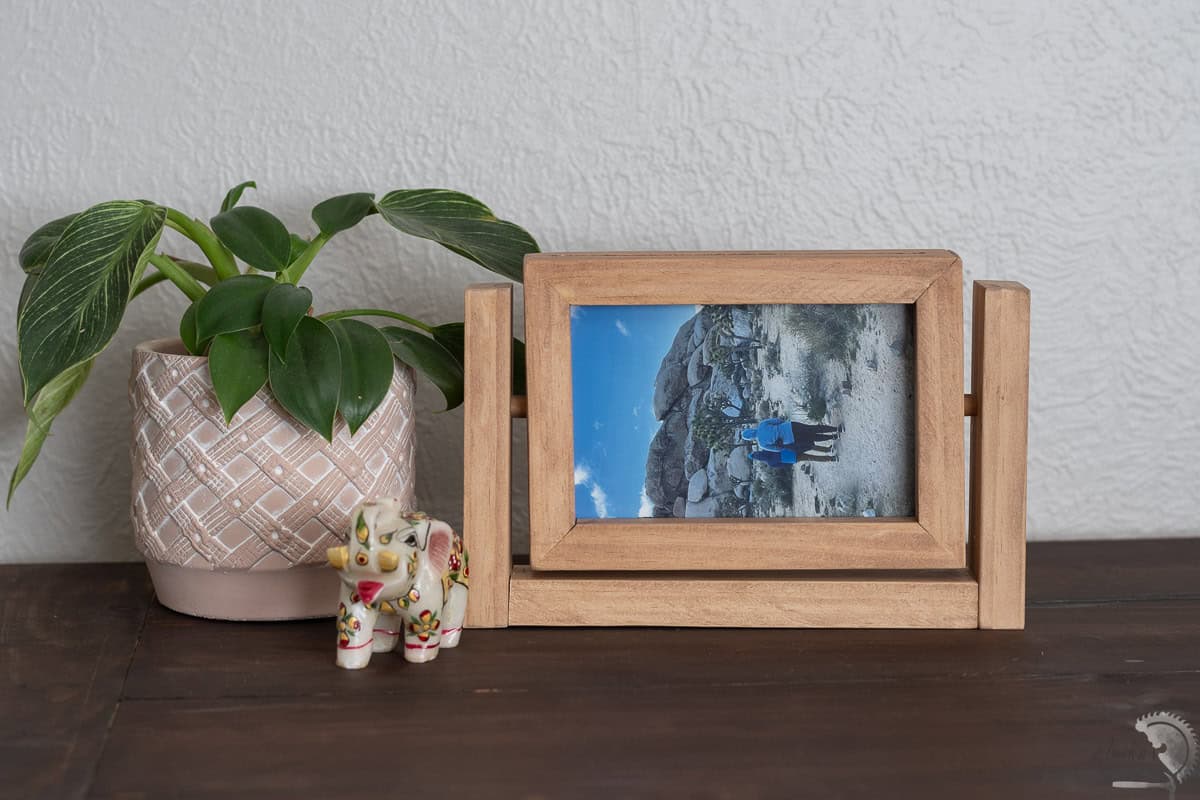 DIY wood rotating picture frame placed horizontally on a desk