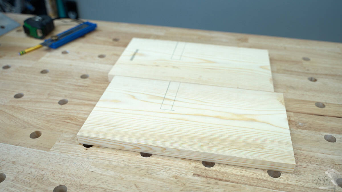 Two 1x8 boards marked for the cut line