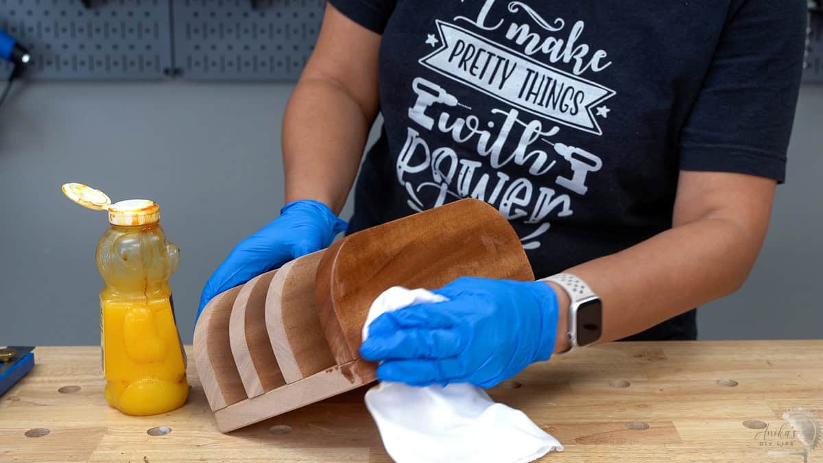 Applying wood finish to the mahogany with a cloth