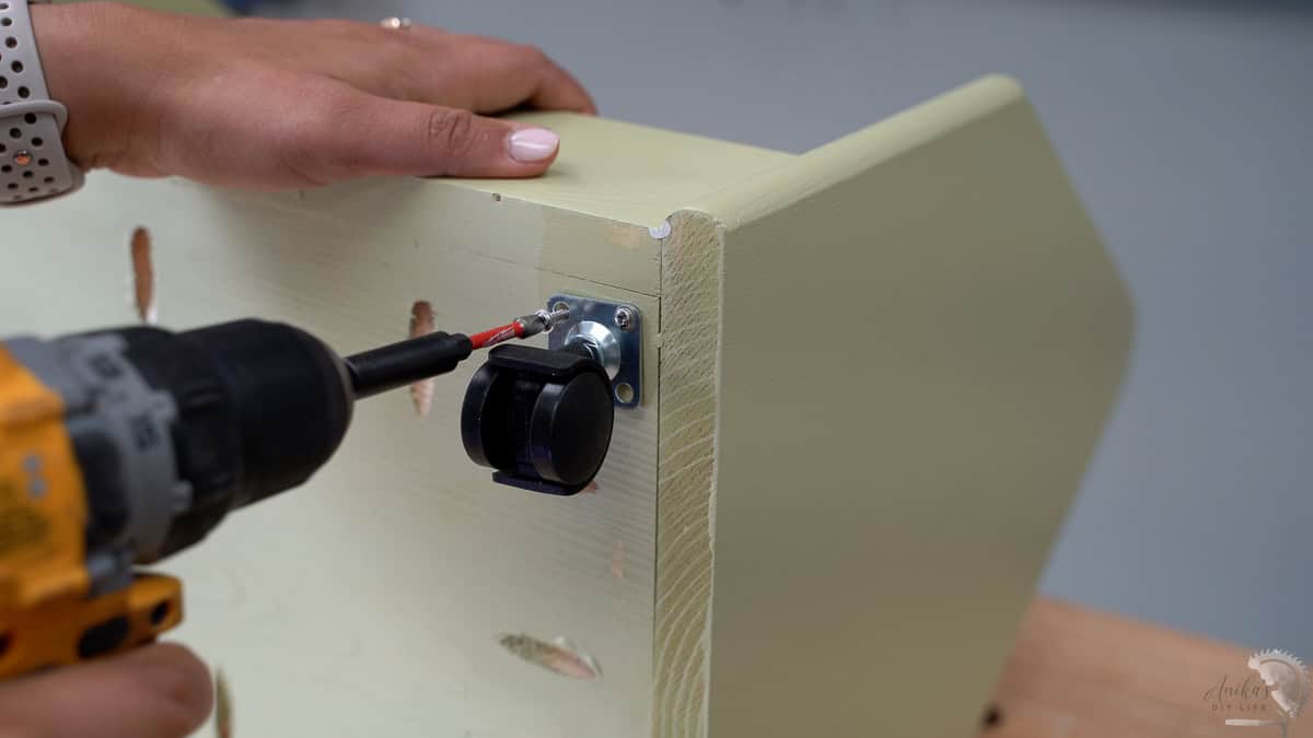 adding the caster to the bottom of the cart