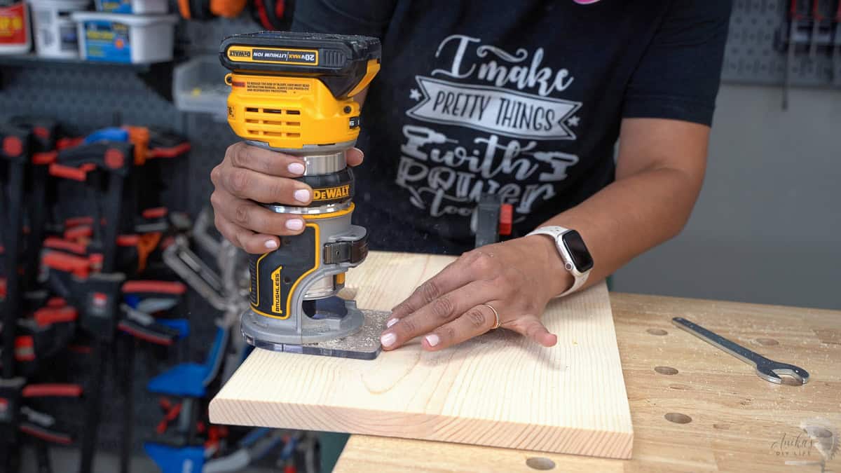 Anika routing the edges of the boards using a router