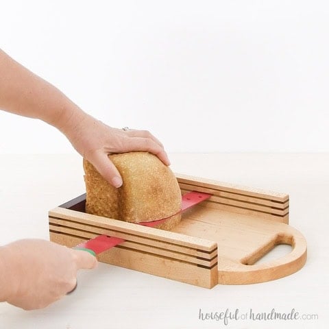 Woman cutting bread on a DIY bread slicer