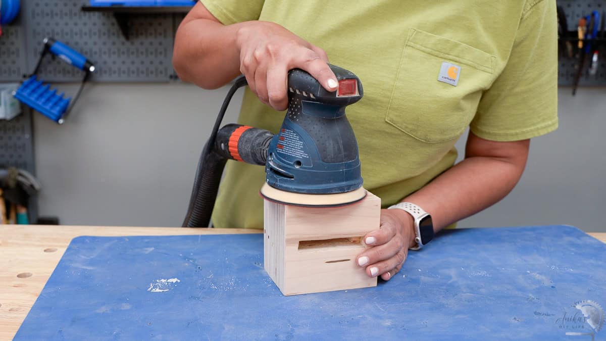 Sanding the phone amplifier using a random orbital sander