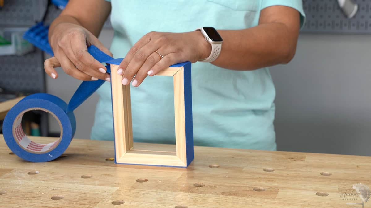 Using painters tape to bind the frame pieces for the glue up