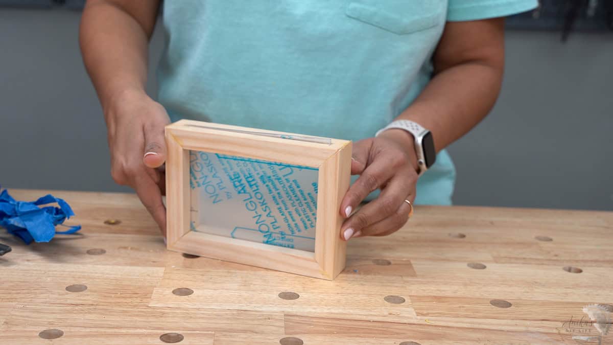 A DIY two sided picture frame with plexiglass inserted.