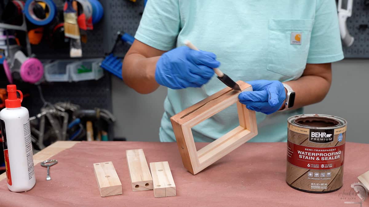 Applying stain to the parts of the rotating picture frame