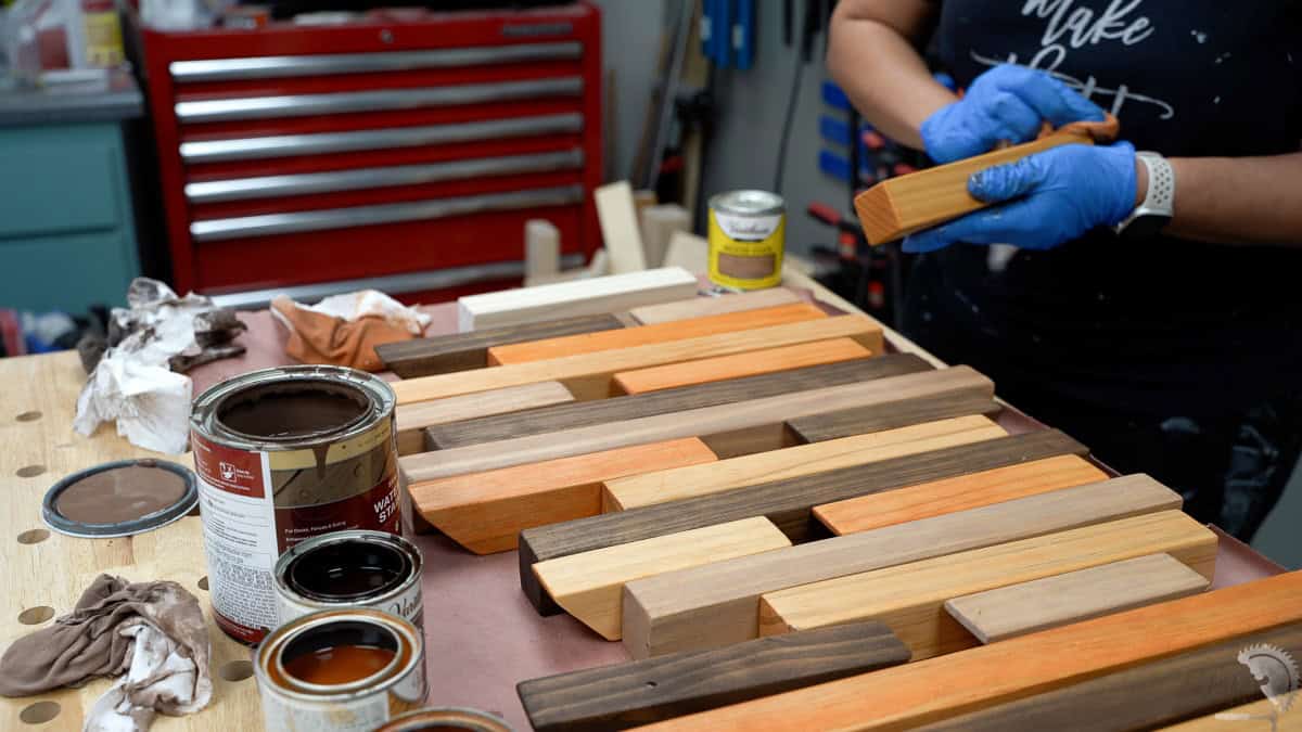 Applying stain to the 2x2 boards for the DIY piano rack