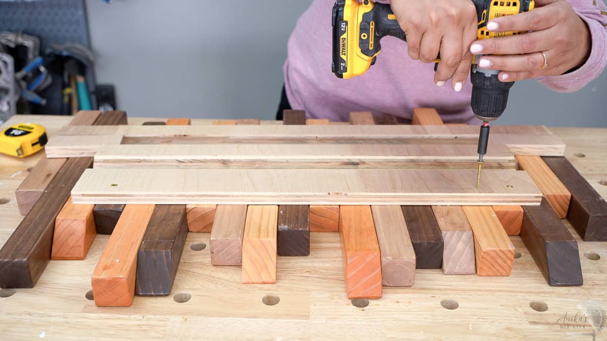 Attaching the french cleat to the back of the DIY coat tack to mount it on the wall