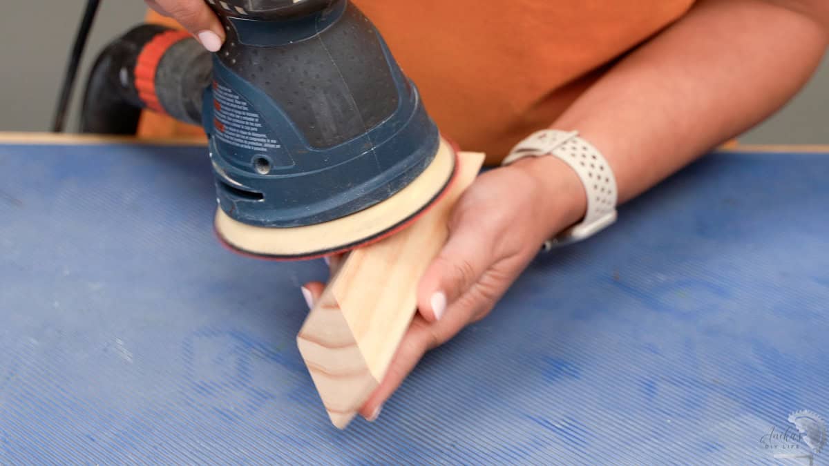Sanding the boards for the DIY coat rack