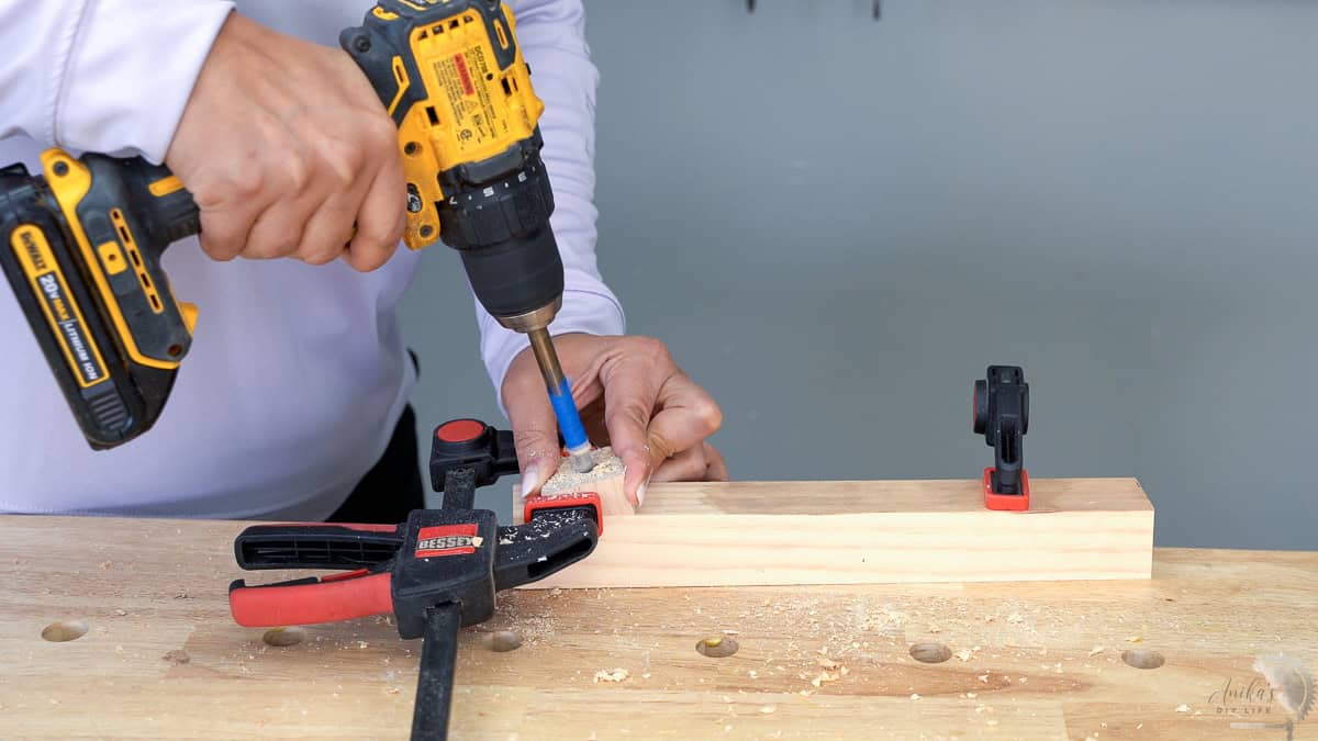 Making the holes for the dowel on the post using the drill guide