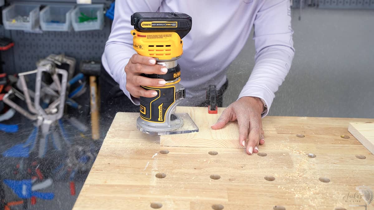 Anika using a router to make the chamfer edge