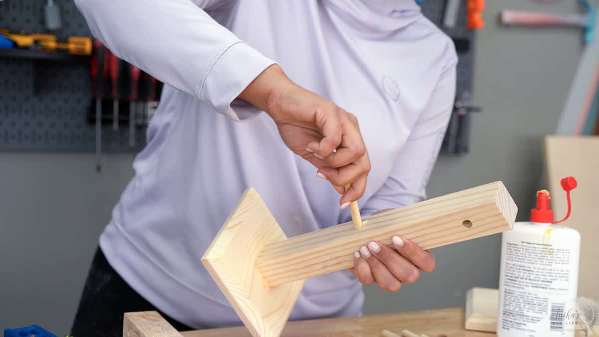 Adding the dowels to the mug tree.