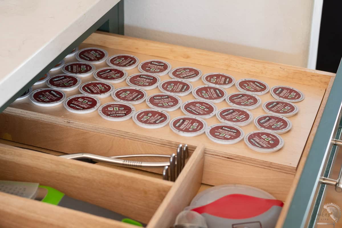 DIY Wooden coffee pod organizer in drawer with coffee pos in it.