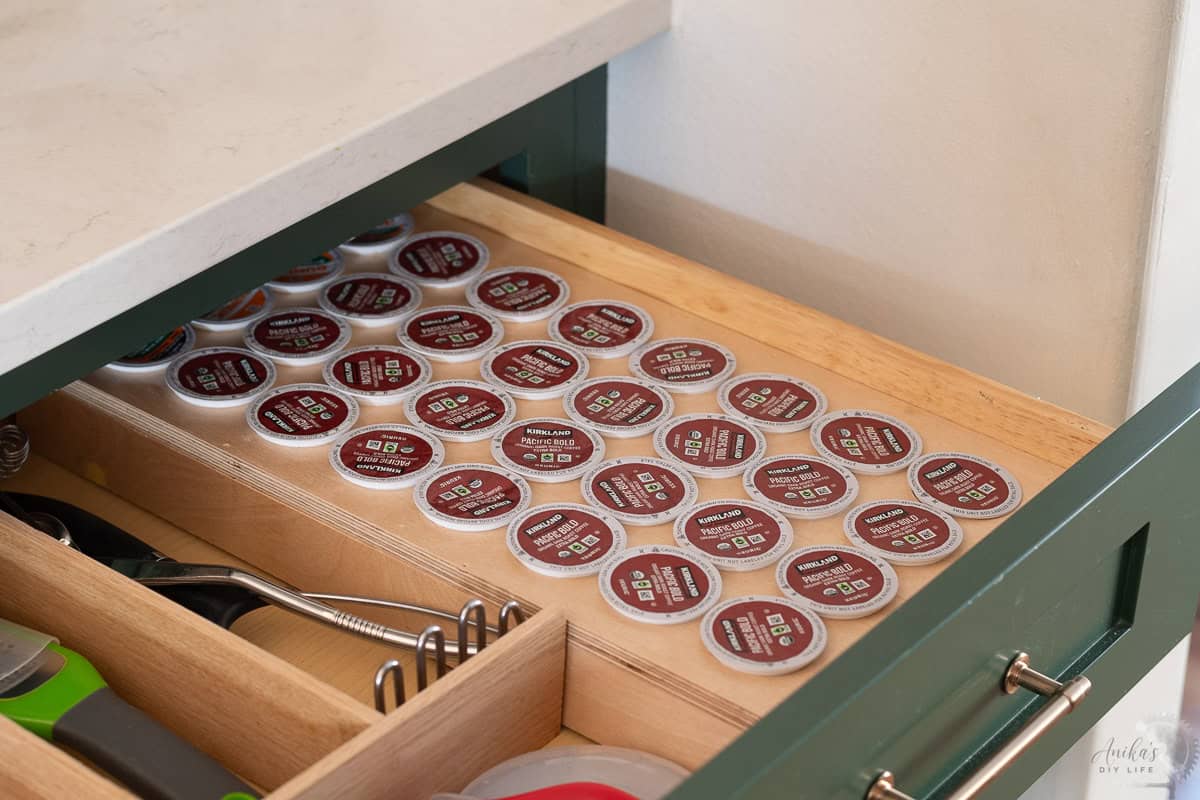 another angle of DIY Wooden coffee pod organizer in drawer with coffee pos in it.