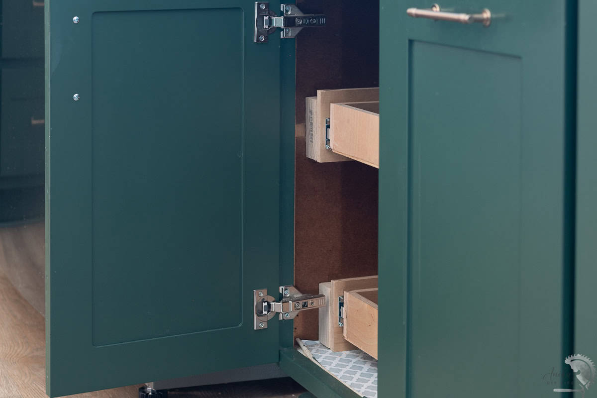 DIY Pull out shelves inside a green cabinet in the kitchen.