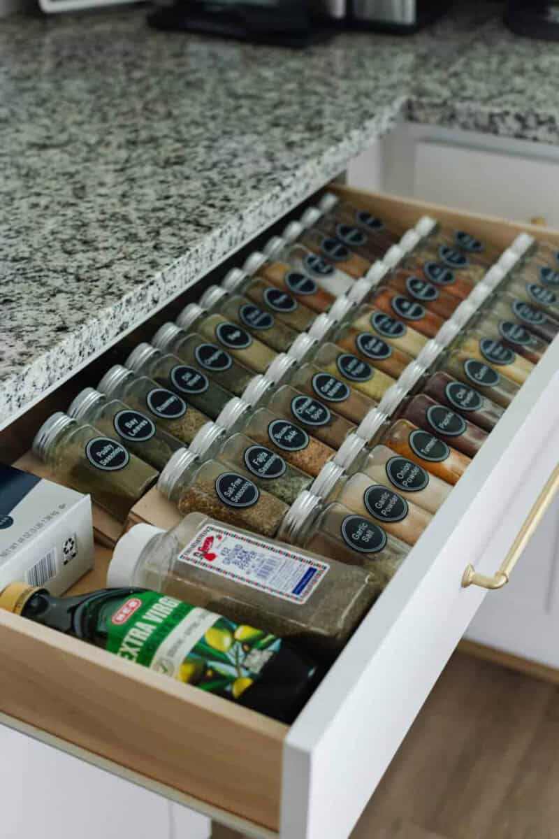 DIY organizer made with scrap wood for a spice drawer with spices on it