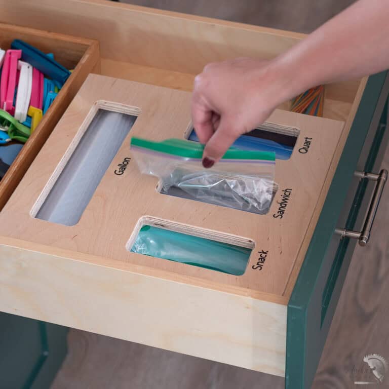Organize your kitchen with this DIY Ziploc Bag Organizer! Learn how to build a food storage bag organizer with compartments and a magnetic lid for easy refilling.