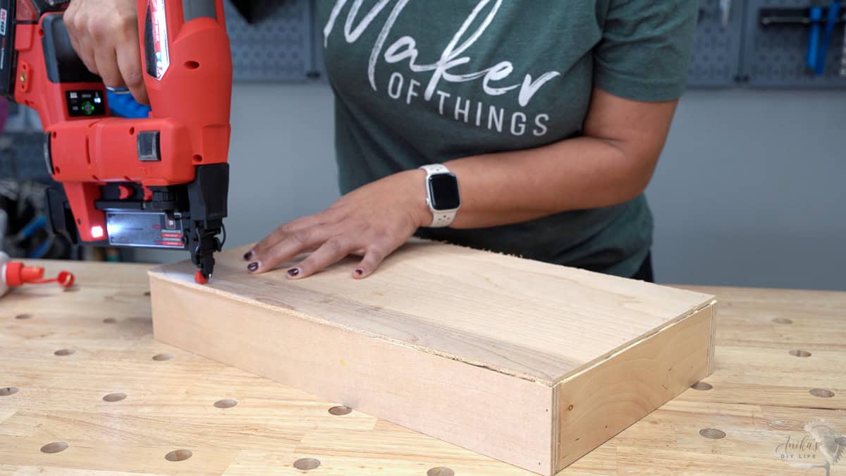 Attaching the bottom of the pull out shelf using a brad nailer