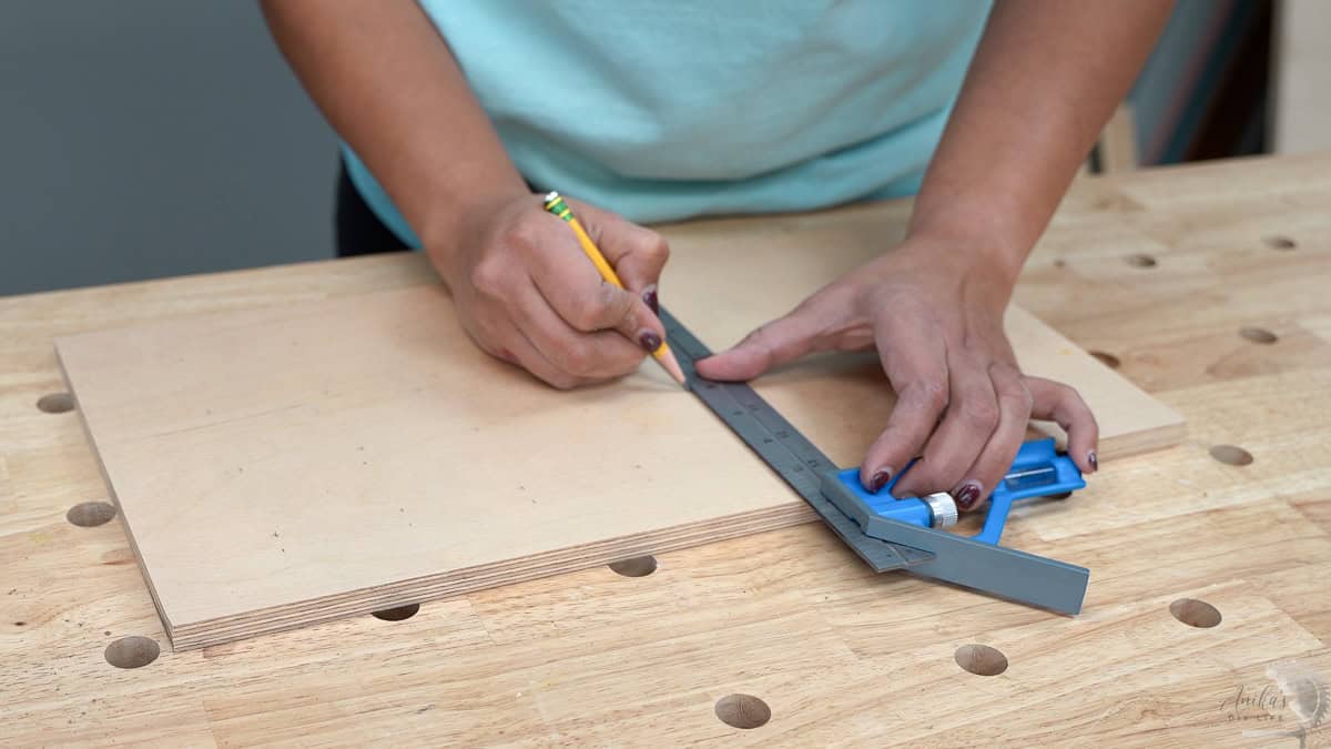 marking location of holes on plywood with a speed square