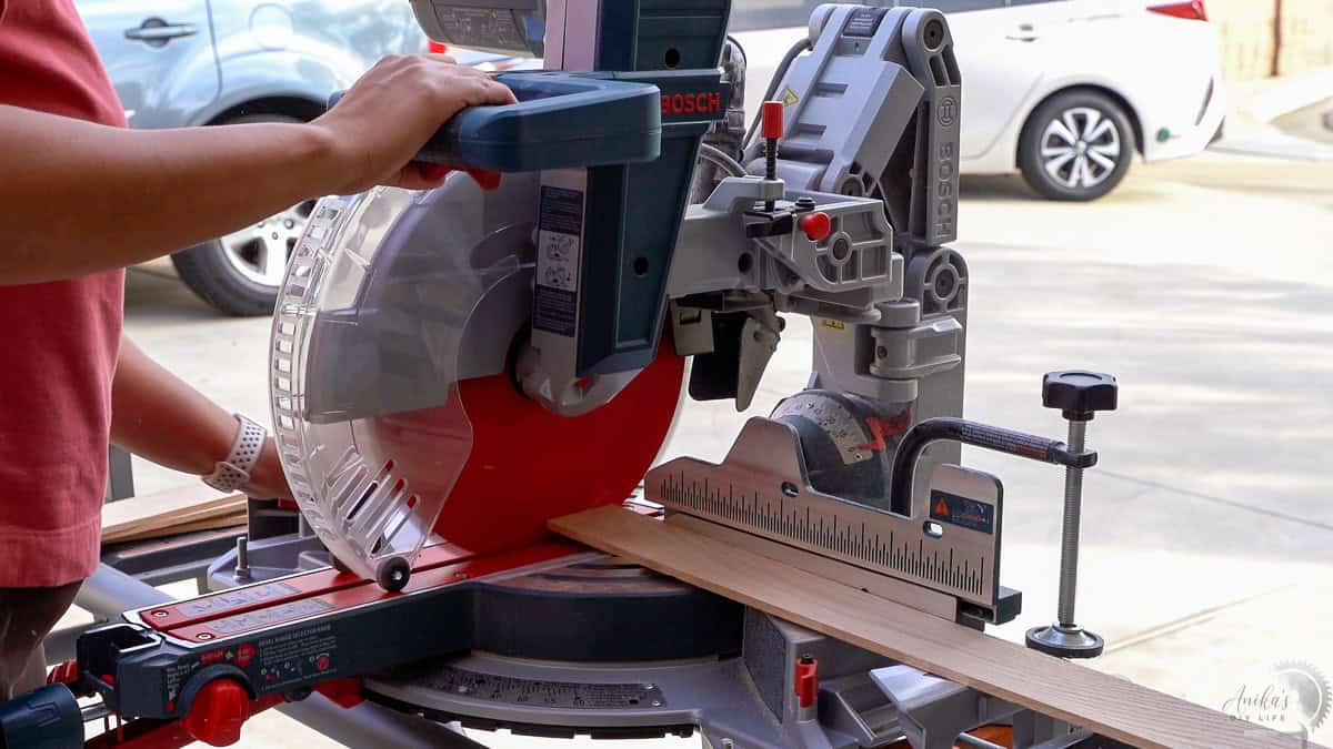cutting wood boards on the miter saw