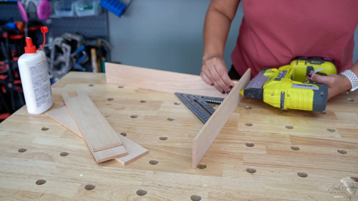 attaching the boards for the drawer organizer using pin nails.