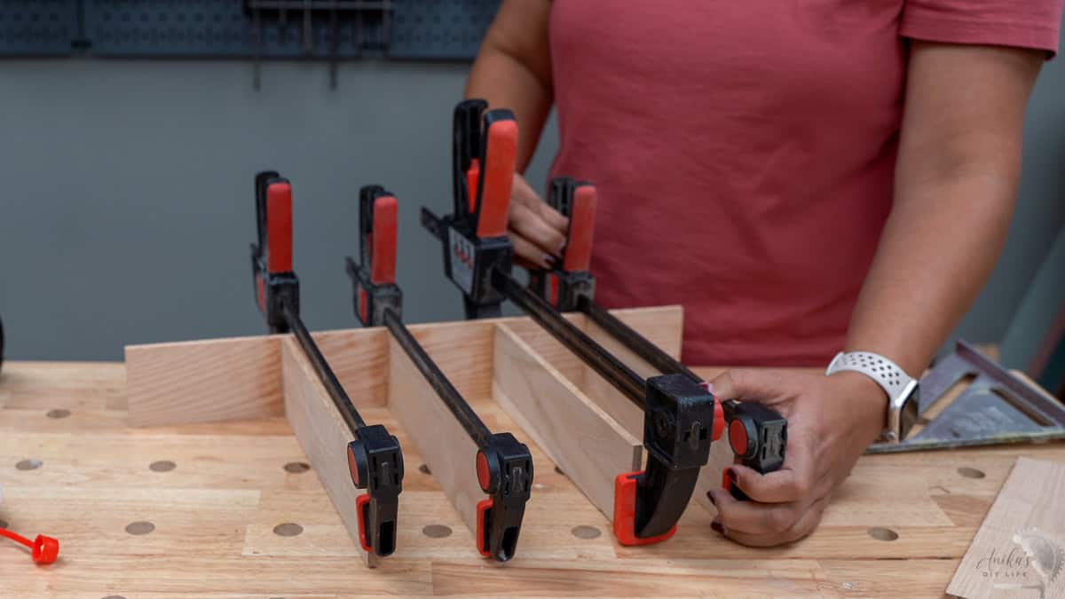 Using clamps to attach the boards for the drawer organizers