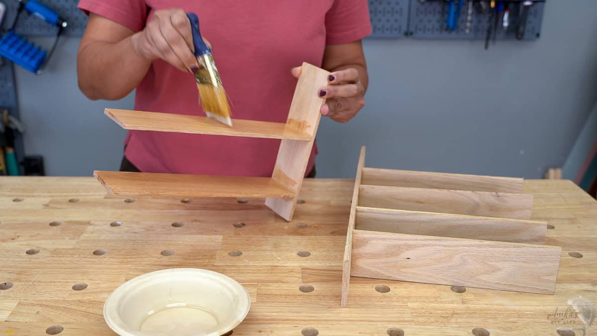 Applying wood sealer to the drawer organizer