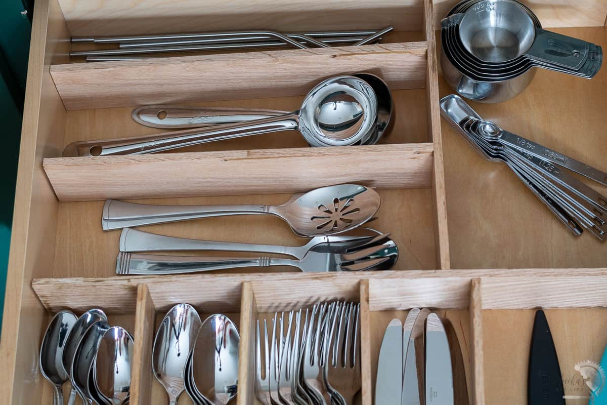DIY wooden kitchen drawer organizer with all silverware neatly arranged.