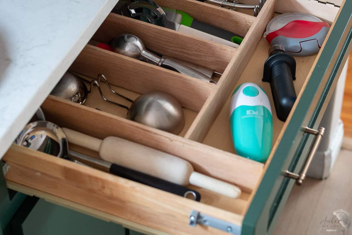 DIY custom drawer organizer made with wood in the drawer with random tools organized