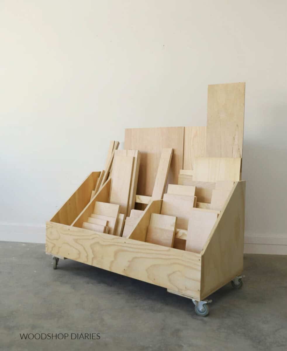 large scrap wood storage cart on wheels containing scrap wood