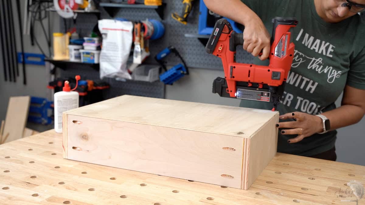 Attaching the bottom of the drawer using finish nails.