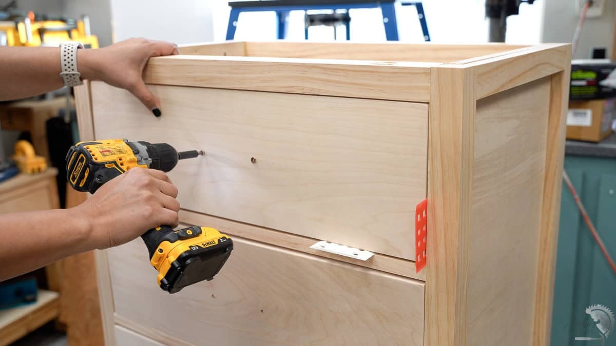 Attaching the drawer front to the drawer in the dresser