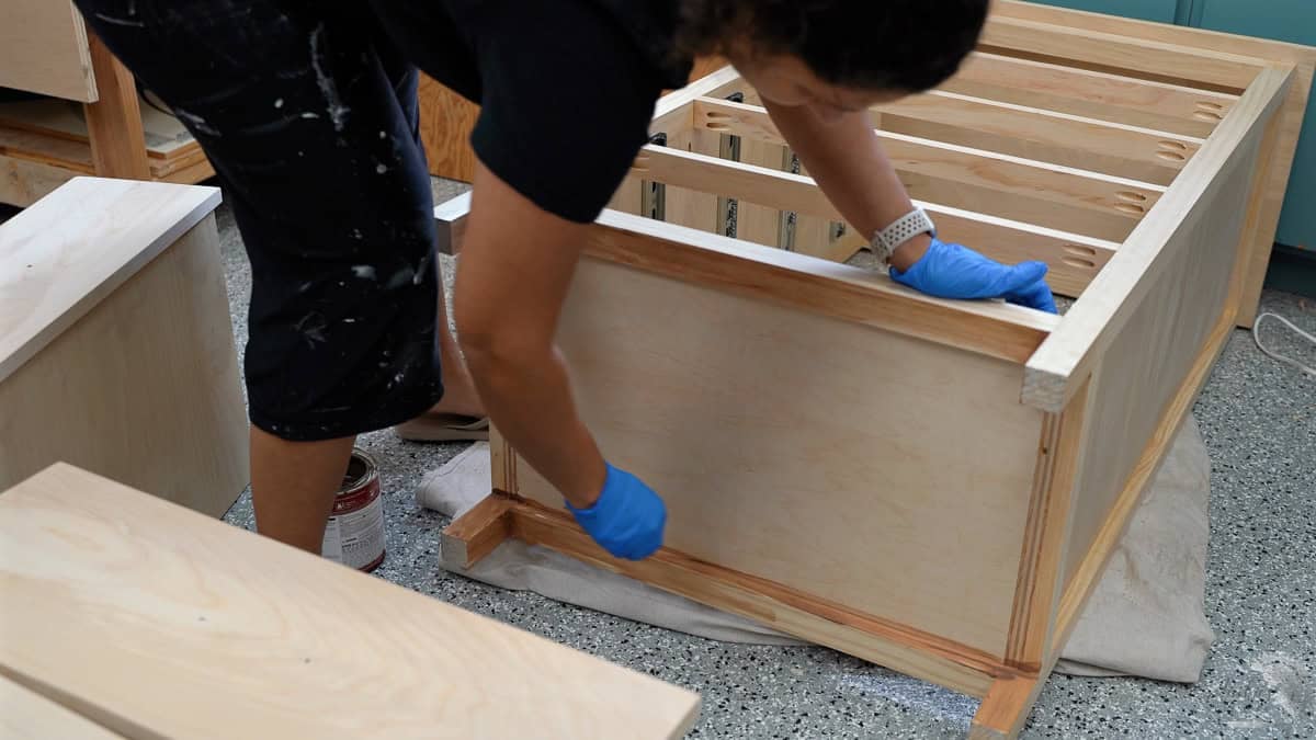 Applying stain to the dresser