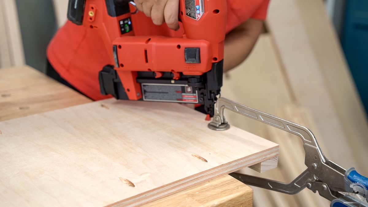Attaching the trim to the sides of the dresser