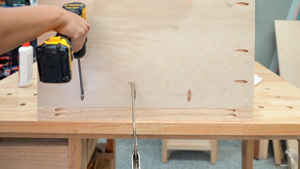 Attaching 2x2 boards to the plywood to make the bottom of the dresser using pocket hole screws