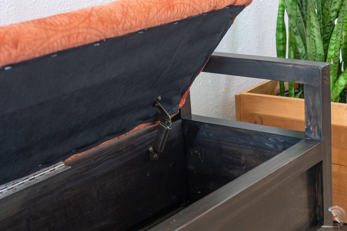 close up of inside the bench showing the lid support hinge